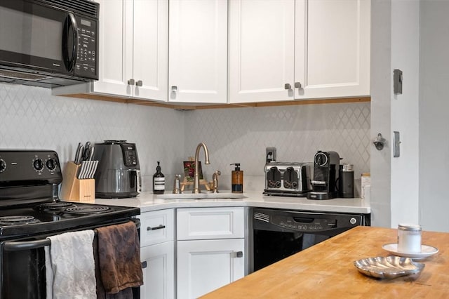 762 Tremont St Unit 5, Boston, MA 02118 - kitchen featuring black appliances, a sink, white cabinets, and decorative backsplash