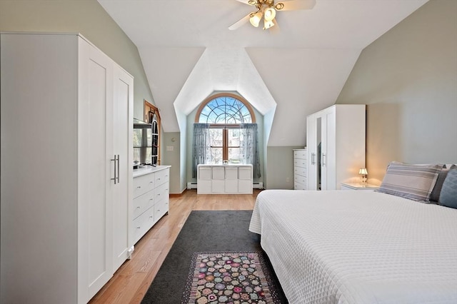 bedroom with light wood-style floors, lofted ceiling, a baseboard radiator, and ceiling fan
