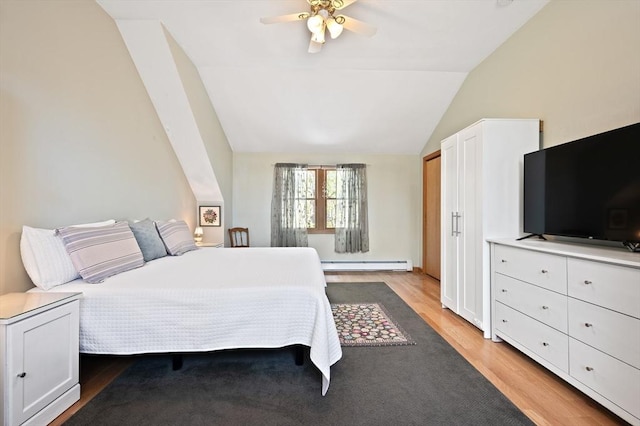 bedroom with a baseboard radiator, light wood-style floors, vaulted ceiling, and a ceiling fan