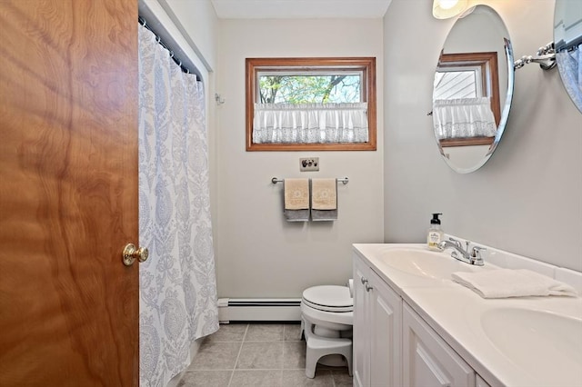 bathroom with baseboard heating, tile patterned flooring, toilet, and double vanity