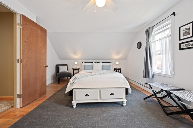 bedroom featuring lofted ceiling, wood finished floors, baseboards, and ceiling fan