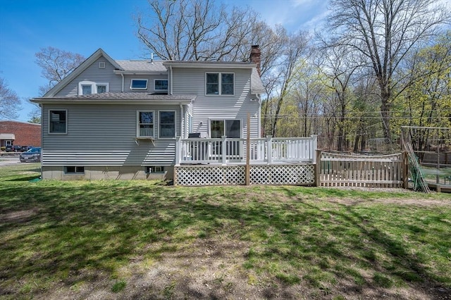 back of property featuring a chimney and a deck