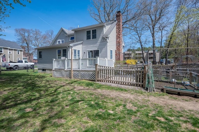 rear view of house featuring a deck and a chimney