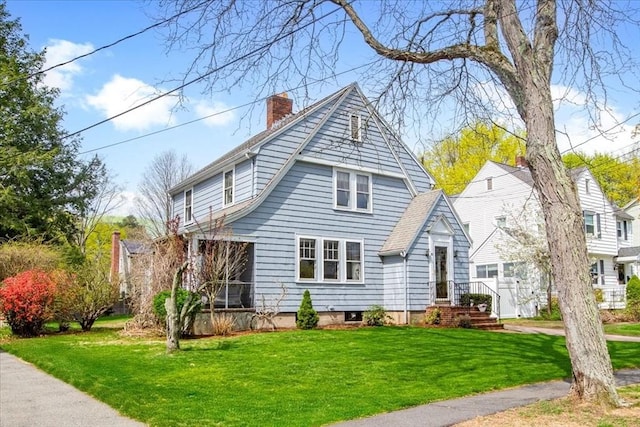 view of front of property featuring a front yard and a chimney