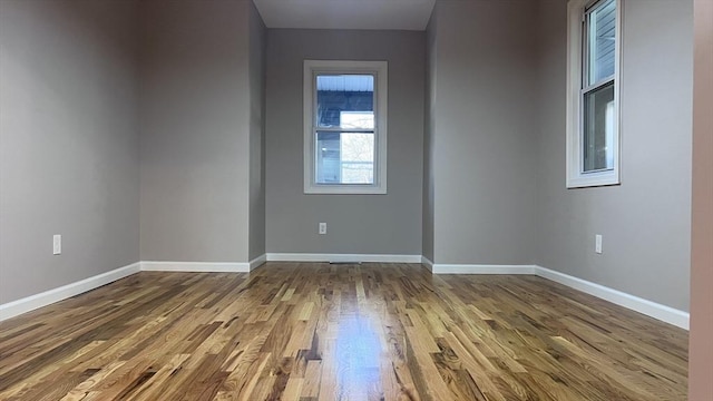 spare room with wood-type flooring