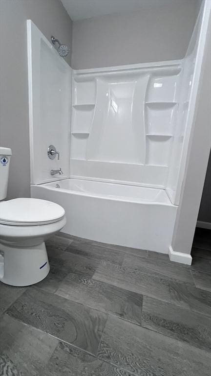 bathroom featuring toilet and shower / washtub combination