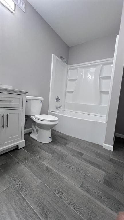 full bathroom featuring shower / bathing tub combination, toilet, and vanity