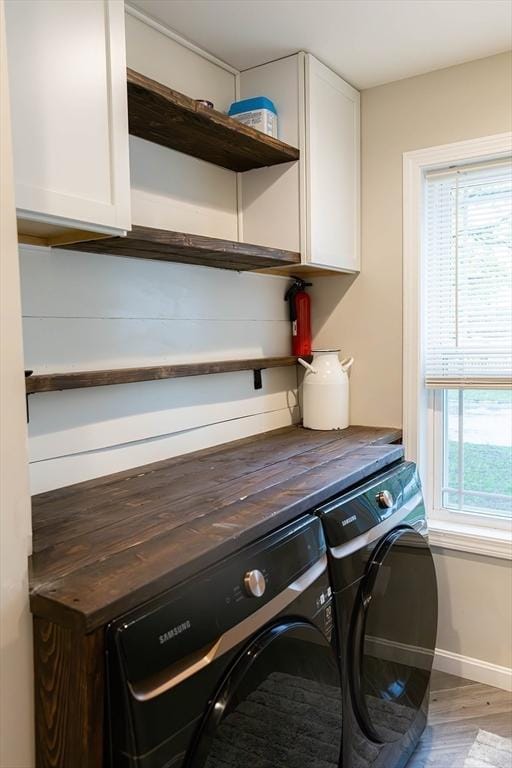 82 Davenport St, Springfield, MA 01119 - washroom featuring cabinet space, washer and clothes dryer, wood finished floors, and baseboards