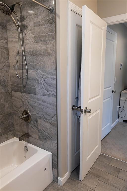 82 Davenport St, Springfield, MA 01119 - full bath with wood finished floors, shower / bath combination, and baseboards
