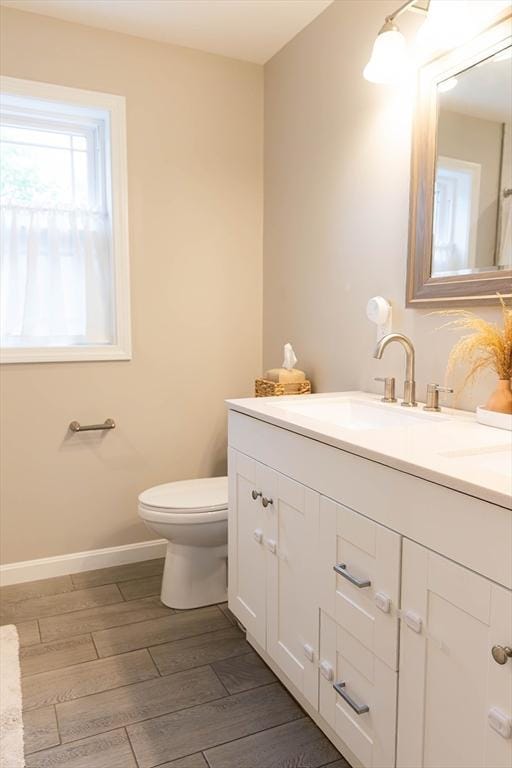 82 Davenport St, Springfield, MA 01119 - bathroom featuring vanity, toilet, wood finished floors, and baseboards