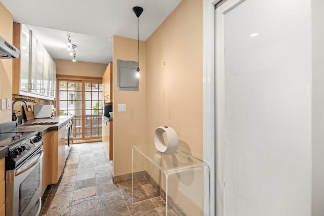15 Concord Sq Unit 1A, Boston, MA 02118 - kitchen with stone tile floors, stainless steel range with electric cooktop, baseboards, pendant lighting, and wall chimney range hood