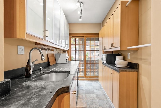 15 Concord Sq Unit 1A, Boston, MA 02118 - kitchen with a sink, dark countertops, black microwave, light stone finish floors, and white cabinetry