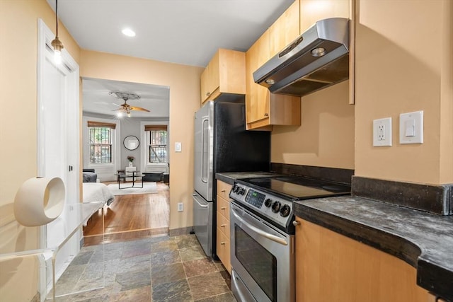 15 Concord Sq Unit 1A, Boston, MA 02118 - kitchen with under cabinet range hood, stainless steel appliances, dark countertops, a ceiling fan, and dark stone finish floors