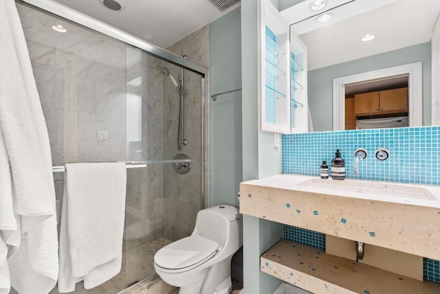 15 Concord Sq Unit 1A, Boston, MA 02118 - bathroom featuring a stall shower, toilet, tasteful backsplash, and a sink