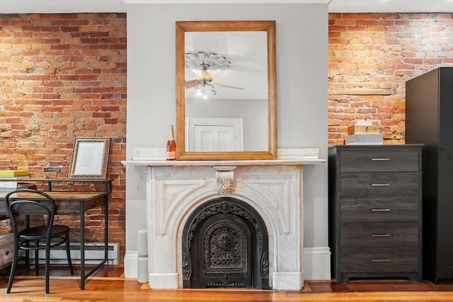 15 Concord Sq Unit 1A, Boston, MA 02118 - detailed view of wood finished floors, brick wall, and a ceiling fan
