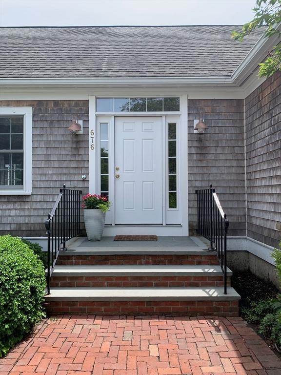 676 Elm St, Dartmouth, MA 02748 - view of exterior entry with roof with shingles