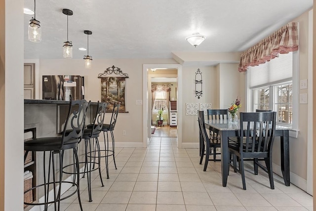 dining room with light tile patterned flooring and baseboards