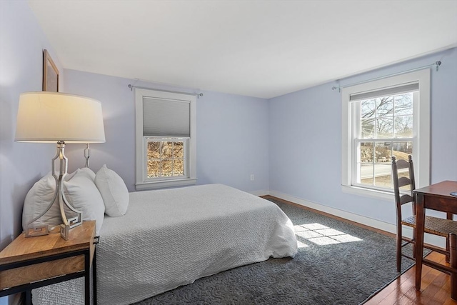 bedroom featuring baseboards and wood finished floors