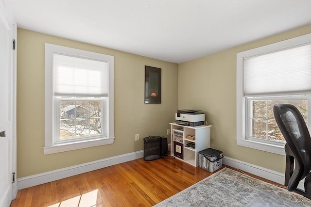 office space with baseboards and wood finished floors