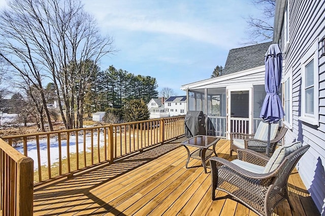 wooden deck with a sunroom