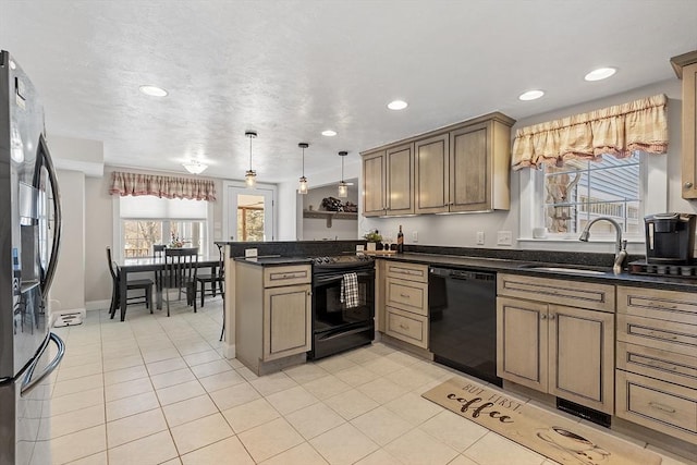 kitchen featuring light tile patterned floors, a peninsula, black appliances, pendant lighting, and a sink