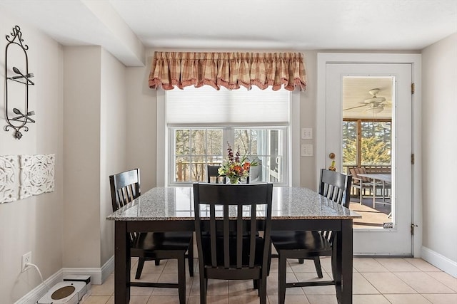 dining area featuring baseboards and light tile patterned floors