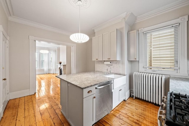 kitchen with radiator heating unit, stainless steel appliances, crown molding, a sink, and light wood finished floors