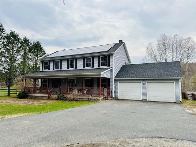 16 E Rd, Adams, MA 01220 - view of front of home with aphalt driveway, fence, solar panels, an attached garage, and covered porch