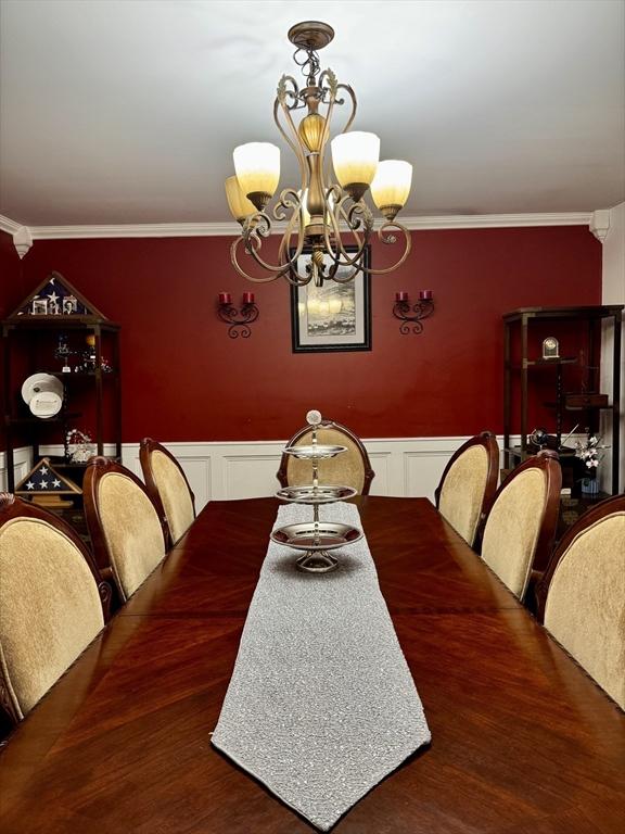 16 E Rd, Adams, MA 01220 - dining area featuring a decorative wall, crown molding, and a notable chandelier