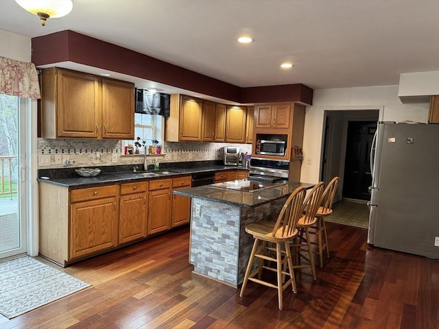 16 E Rd, Adams, MA 01220 - kitchen with a breakfast bar, dark wood-style floors, a sink, and black appliances