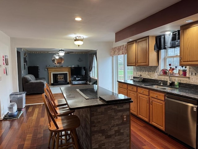 16 E Rd, Adams, MA 01220 - kitchen featuring stainless steel dishwasher, a sink, brown cabinetry, a breakfast bar, and dark wood finished floors