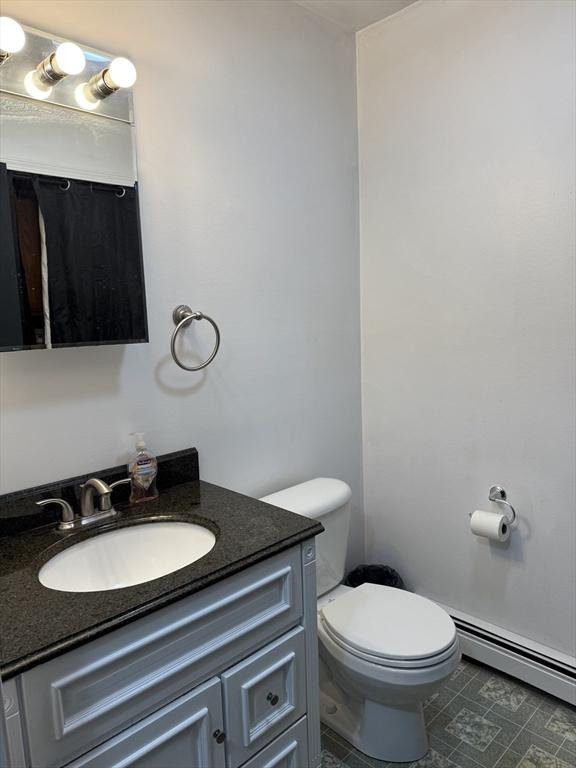 16 E Rd, Adams, MA 01220 - half bath with a baseboard heating unit, vanity, and toilet