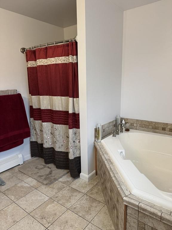 16 E Rd, Adams, MA 01220 - full bath with a baseboard heating unit, a garden tub, tile patterned flooring, and a shower with shower curtain