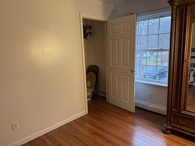 16 E Rd, Adams, MA 01220 - unfurnished bedroom with wood finished floors, baseboard heating, and multiple windows