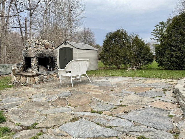 16 E Rd, Adams, MA 01220 - view of patio with an outdoor stone fireplace, a storage unit, and an outdoor structure