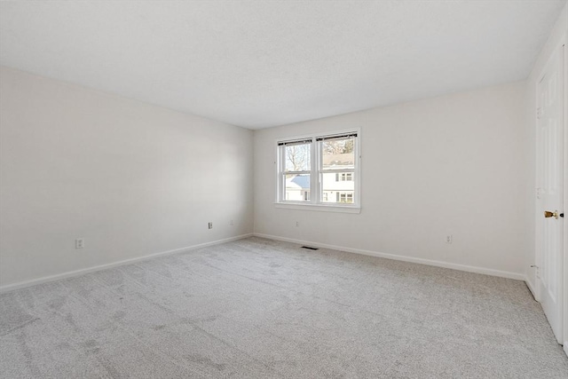 empty room featuring light carpet