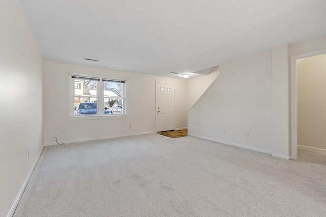 empty room featuring light carpet