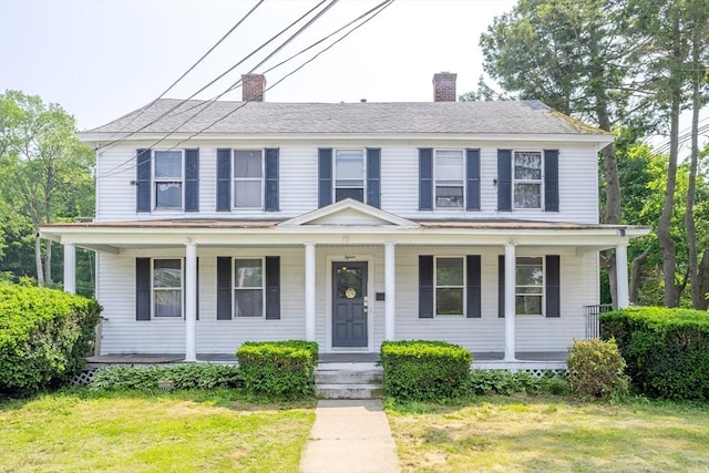 15 Green St, Gardner, MA 01440 - colonial inspired home featuring a chimney, covered porch, and a front yard