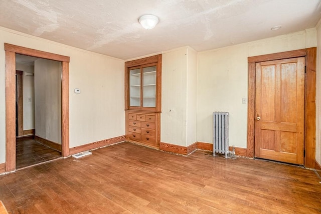 15 Green St, Gardner, MA 01440 - spare room featuring radiator heating unit and wood finished floors