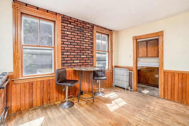 15 Green St, Gardner, MA 01440 - dining area with radiator, wainscoting, hardwood / wood-style flooring, wooden walls, and a dry bar