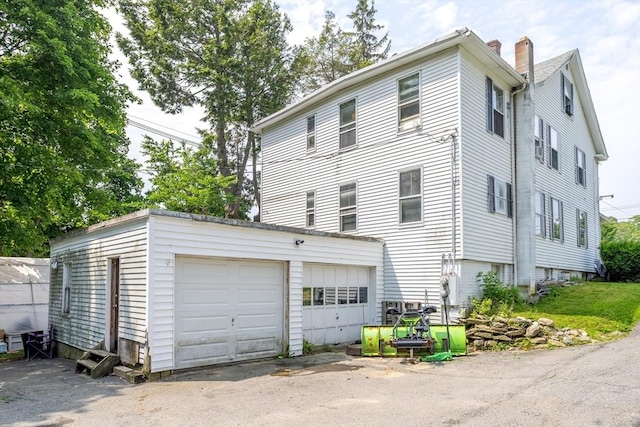 15 Green St, Gardner, MA 01440 - view of side of property featuring an outbuilding, a garage, and a chimney