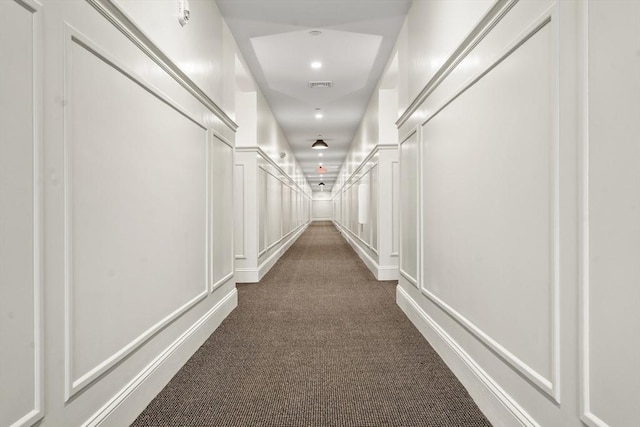 hallway with dark carpet