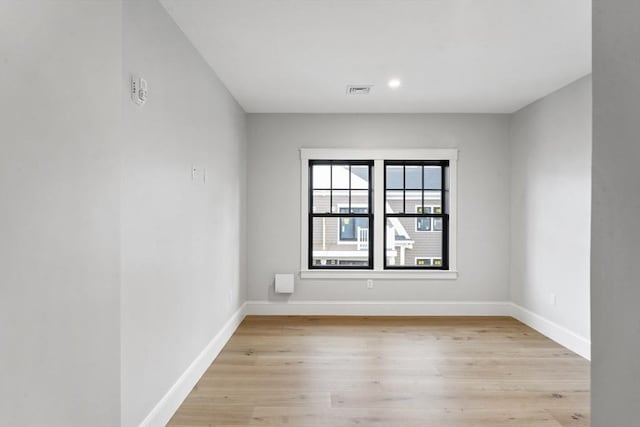 spare room with light wood-type flooring