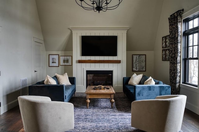 living room featuring lofted ceiling and dark hardwood / wood-style floors