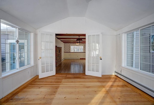 interior space with light wood-style floors, lofted ceiling, french doors, and baseboard heating