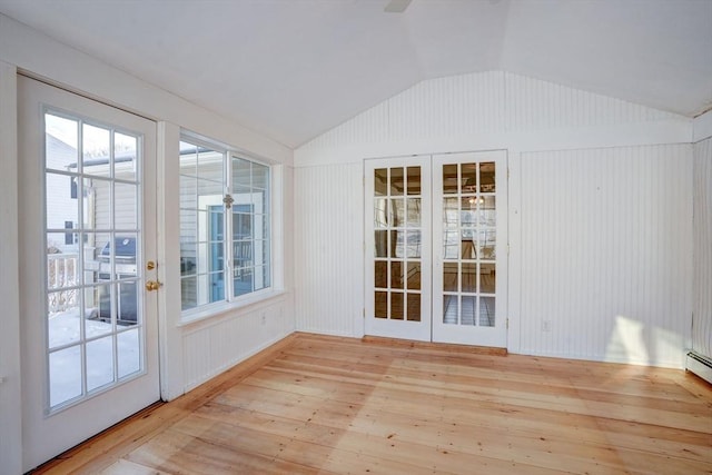 unfurnished sunroom featuring vaulted ceiling and french doors