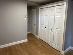 520 Shawmut Ave Unit 1, Boston, MA 02118 - unfurnished bedroom with a closet, baseboards, and wood finished floors