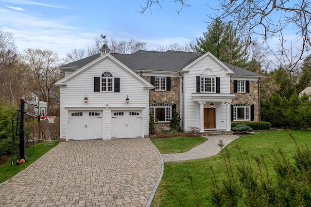 view of front facade with a garage and a front lawn