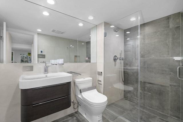 bathroom with toilet, walk in shower, vanity, and tile walls