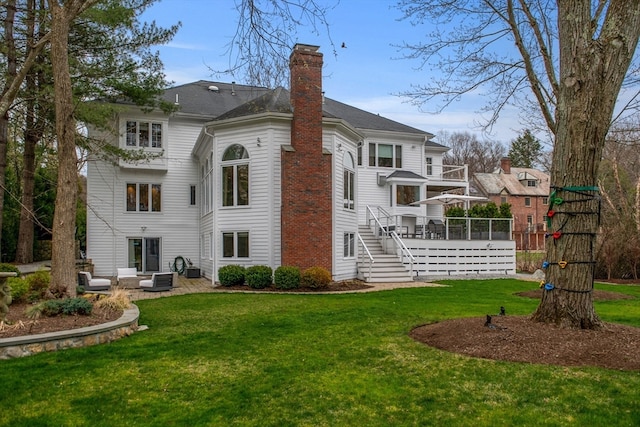 rear view of house with a patio area and a lawn